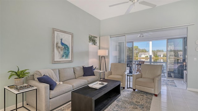 living room featuring light tile patterned floors, baseboards, and ceiling fan