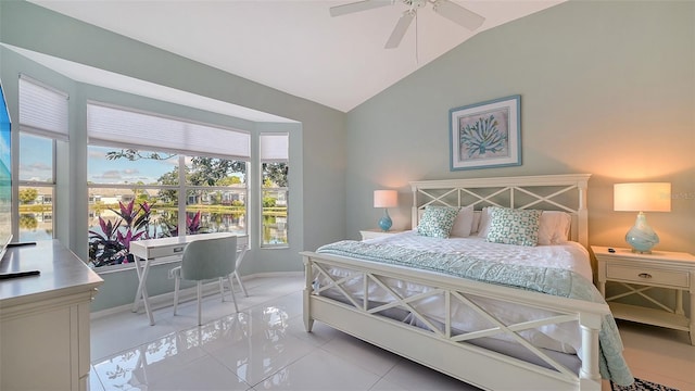 bedroom with vaulted ceiling, light tile patterned floors, baseboards, and ceiling fan