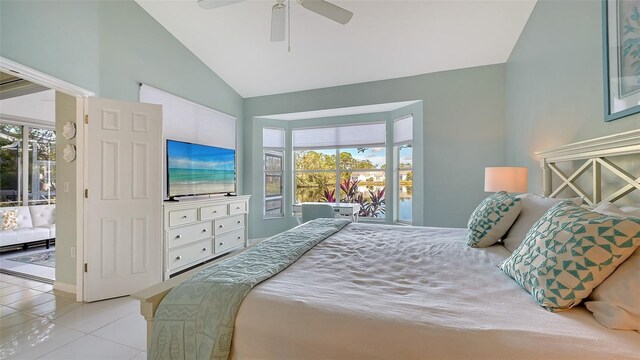 bedroom featuring multiple windows, lofted ceiling, a ceiling fan, and tile patterned flooring