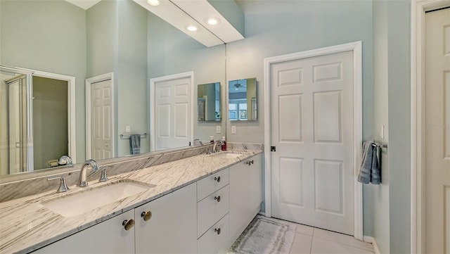 bathroom featuring a sink, an enclosed shower, recessed lighting, and double vanity