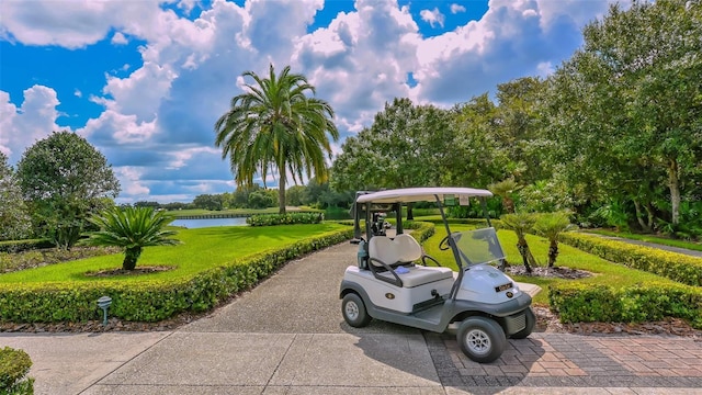 surrounding community featuring a lawn and a water view