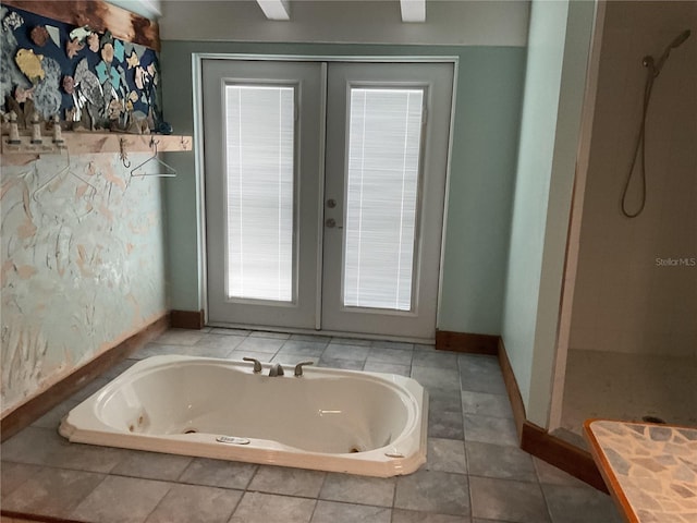 bathroom with a jetted tub, french doors, baseboards, and walk in shower