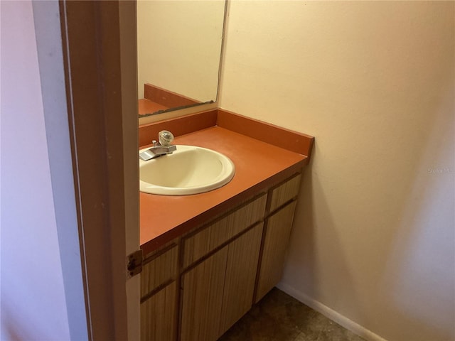 bathroom featuring baseboards and vanity