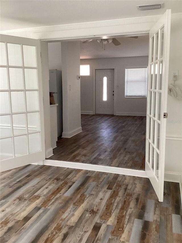 entrance foyer with wood finished floors, a ceiling fan, visible vents, and baseboards