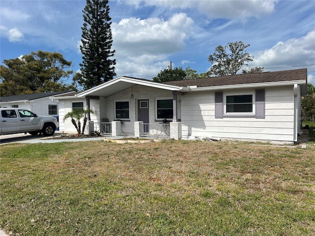 3525 Emory Dr, Holiday, FL 34691 - single story home featuring a front yard and a porch