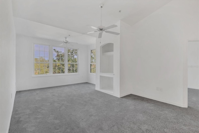 empty room with baseboards, carpet floors, ceiling fan, and vaulted ceiling