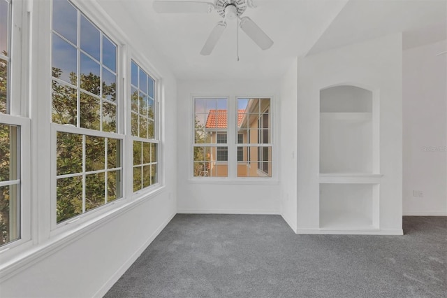 unfurnished sunroom featuring plenty of natural light and ceiling fan