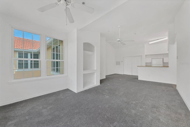 unfurnished room featuring baseboards, a ceiling fan, and dark colored carpet