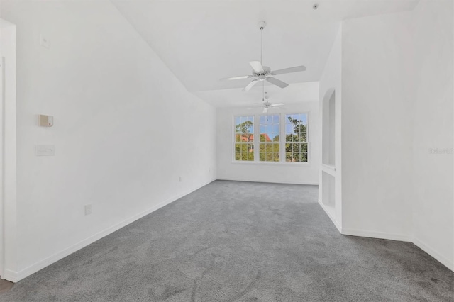 empty room with baseboards, carpet, ceiling fan, and vaulted ceiling