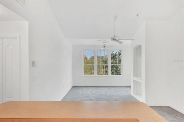 empty room featuring visible vents, baseboards, carpet, and a ceiling fan