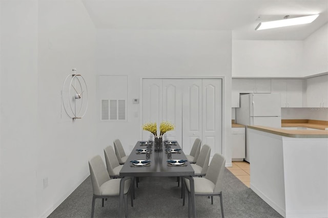 dining room featuring light tile patterned flooring and visible vents