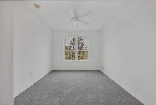 unfurnished room featuring carpet flooring, baseboards, and a ceiling fan