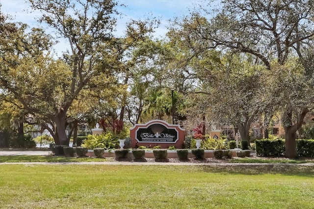 community sign featuring a yard