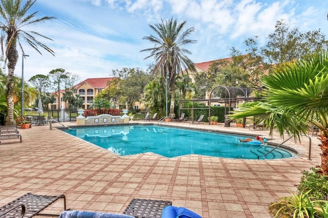 pool featuring a patio area and fence