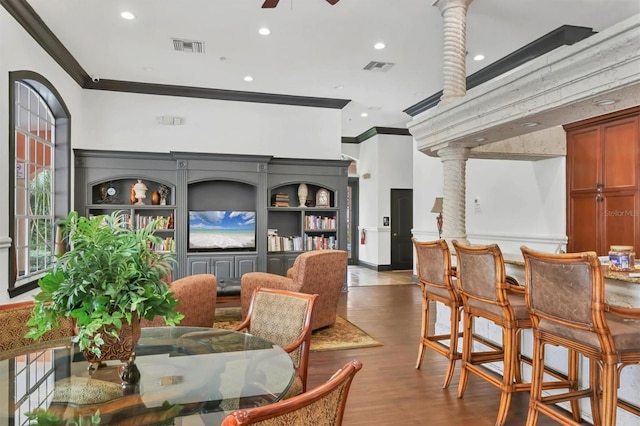 dining area with crown molding, visible vents, and ceiling fan