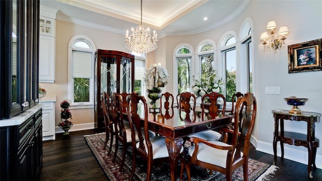 dining space featuring dark wood-type flooring, a tray ceiling, an inviting chandelier, crown molding, and baseboards