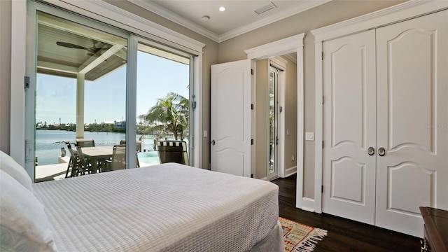 bedroom with dark wood-style floors, baseboards, access to exterior, a water view, and crown molding