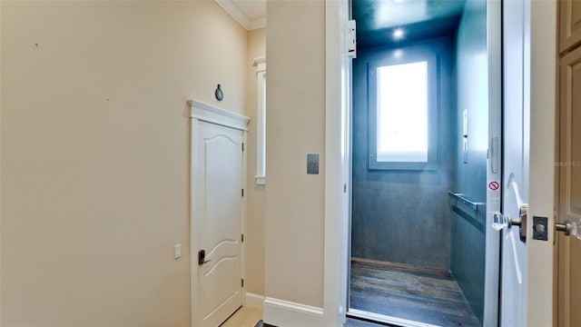 interior space with crown molding and baseboards