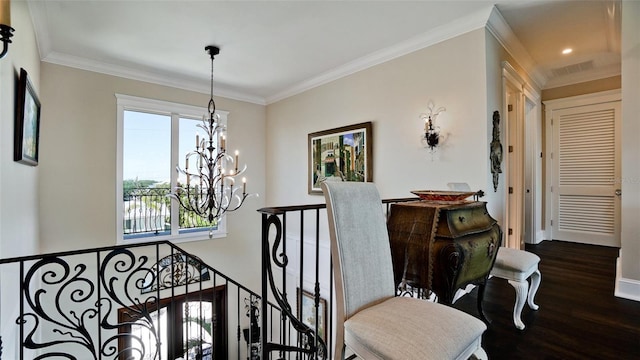 staircase featuring baseboards, crown molding, an inviting chandelier, and wood finished floors