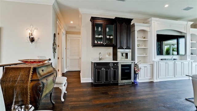 bar with wine cooler, dark wood finished floors, indoor wet bar, and ornamental molding