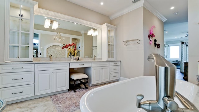 bathroom featuring recessed lighting, vanity, a freestanding bath, and crown molding