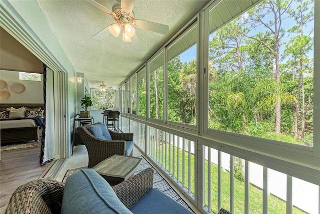 sunroom / solarium featuring a wealth of natural light and a ceiling fan