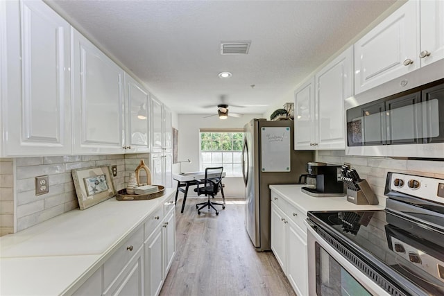 kitchen featuring white cabinetry, visible vents, and stainless steel appliances