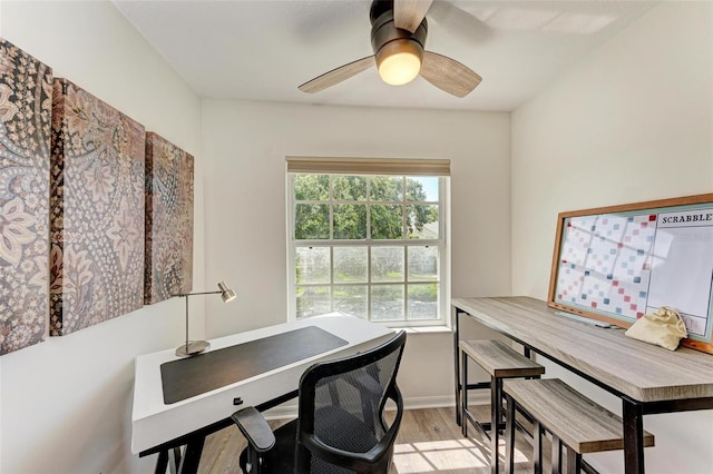 office with baseboards, light wood-style floors, and ceiling fan