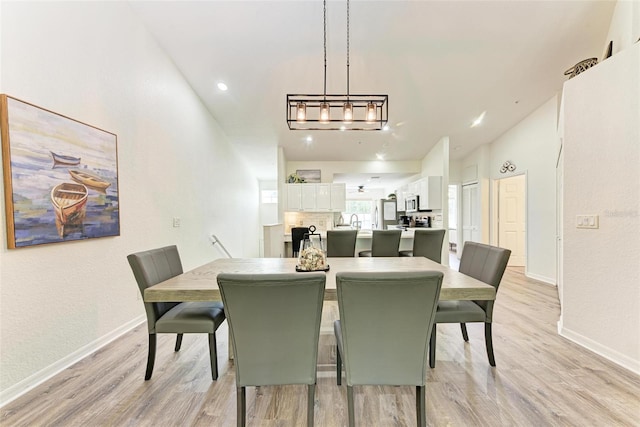 dining room with light wood finished floors and baseboards