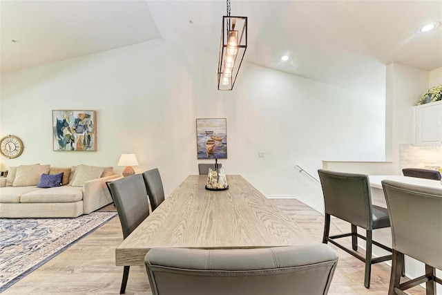 dining area featuring vaulted ceiling, recessed lighting, and light wood-style floors