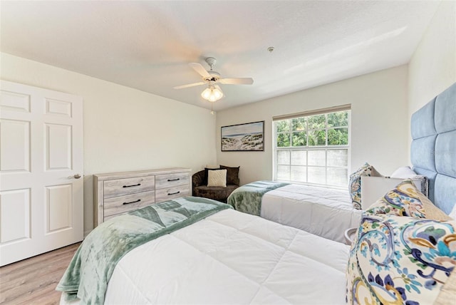 bedroom featuring light wood-type flooring and ceiling fan