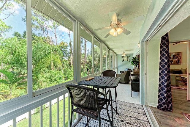 sunroom with a ceiling fan and a wealth of natural light