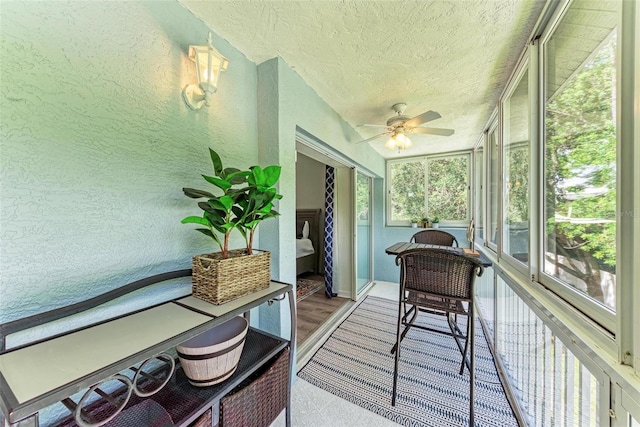 sunroom featuring ceiling fan