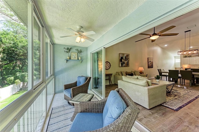 living room with lofted ceiling, wood finished floors, and ceiling fan