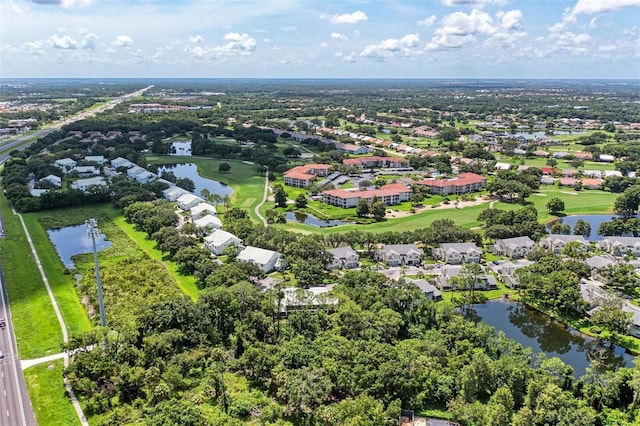 aerial view featuring view of golf course, a water view, and a residential view