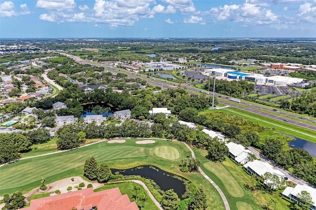 birds eye view of property with a water view and view of golf course