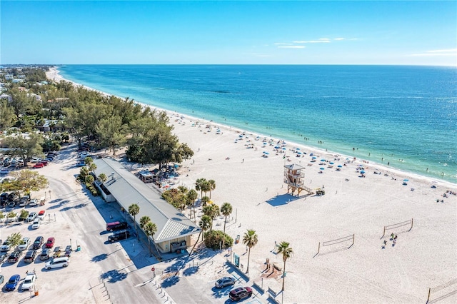 drone / aerial view featuring a water view and a beach view