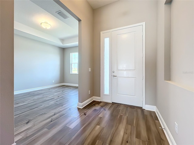 entryway with visible vents, baseboards, and wood finished floors