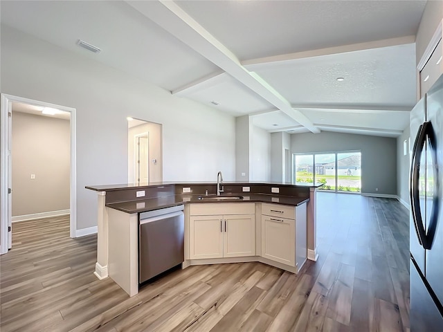 kitchen featuring visible vents, open floor plan, a center island with sink, appliances with stainless steel finishes, and a sink