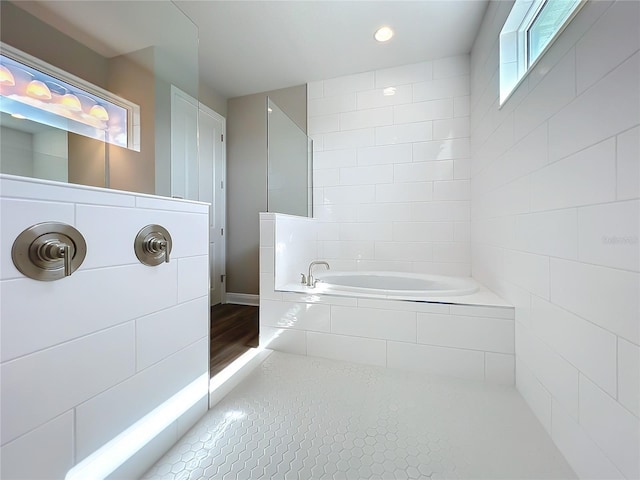 bathroom with a bath, tile patterned floors, and walk in shower