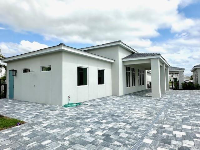 exterior space featuring a patio area and stucco siding