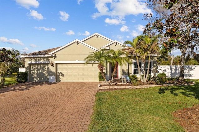 single story home featuring fence, an attached garage, stucco siding, a front lawn, and decorative driveway