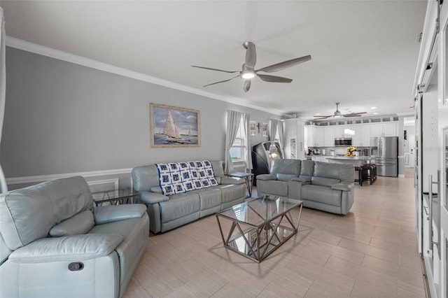 living room featuring ornamental molding and a ceiling fan