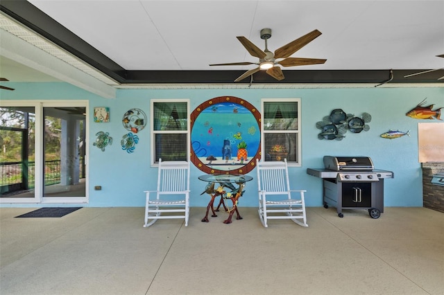 view of patio with area for grilling and a ceiling fan