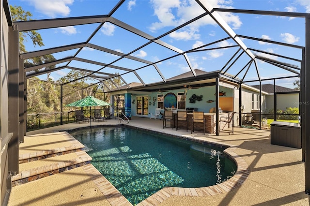 outdoor pool featuring a patio area, a lanai, outdoor dry bar, and a ceiling fan