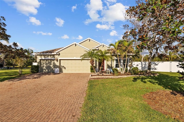 view of front of house with fence, stucco siding, a front lawn, a garage, and decorative driveway