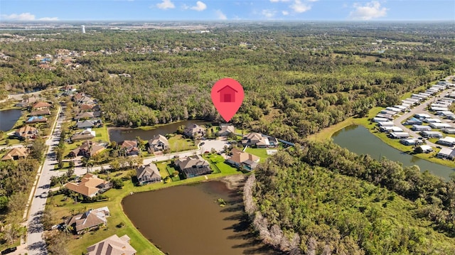 bird's eye view featuring a view of trees, a water view, and a residential view