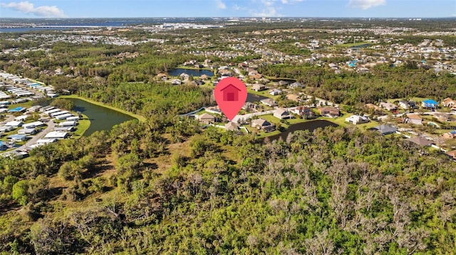 aerial view featuring a wooded view and a water view