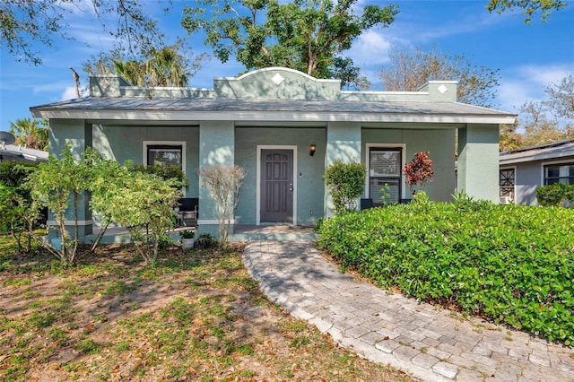 view of front of property featuring stucco siding and covered porch