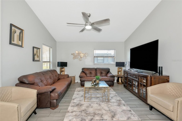 living area featuring lofted ceiling, plenty of natural light, wood tiled floor, and ceiling fan